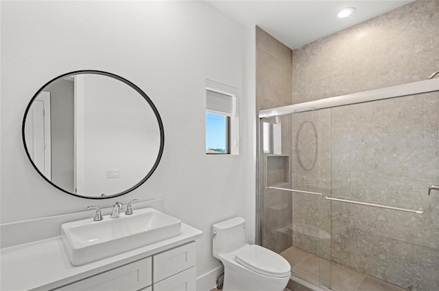 full bath with vanity, toilet, and a shower stall