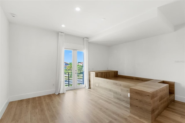 spare room featuring recessed lighting, baseboards, and wood finished floors