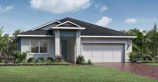 view of front of property with stucco siding, decorative driveway, a front yard, and a garage