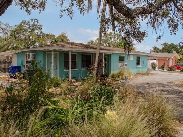 single story home with concrete driveway, stucco siding, and fence