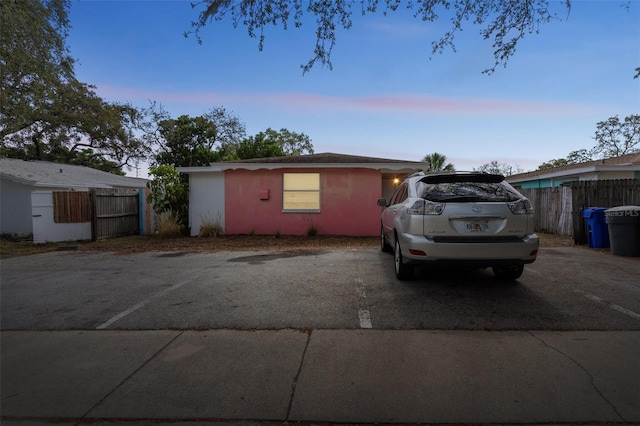 view of front of home with fence and stucco siding
