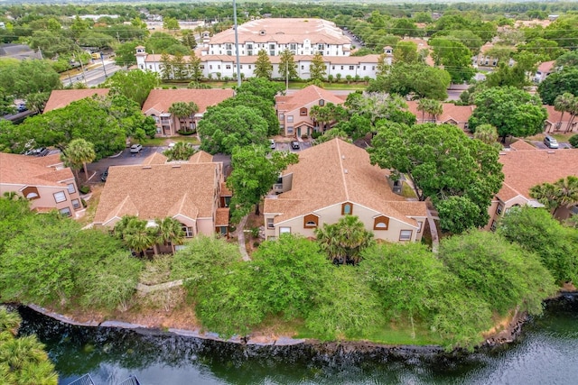 birds eye view of property with a water view and a residential view