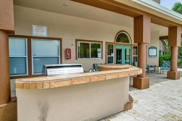 view of patio with an outdoor kitchen and french doors