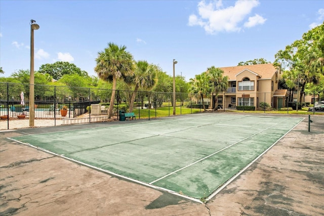 view of tennis court with fence