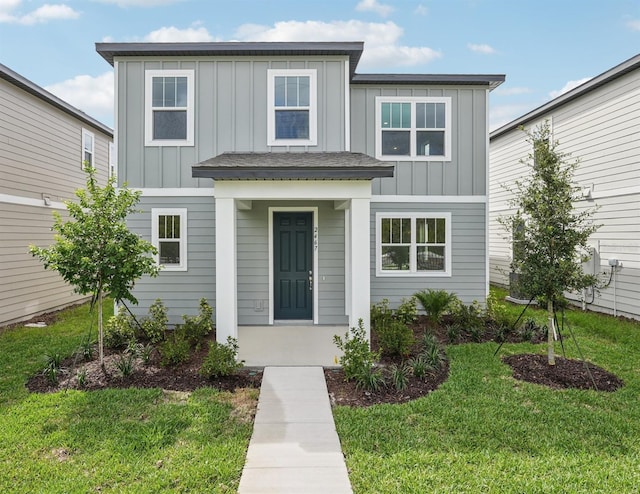 2467 Zuni Rd, Saint Cloud, FL 34771 - view of front of property with board and batten siding and a front yard