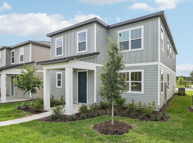 2467 Zuni Rd, Saint Cloud, FL 34771 - view of front facade with board and batten siding and a front lawn