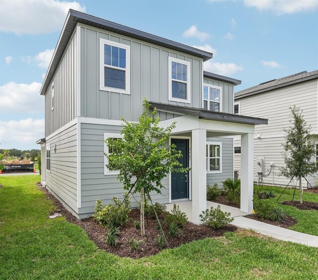 2467 Zuni Rd, Saint Cloud, FL 34771 - view of front of property with board and batten siding and a front lawn