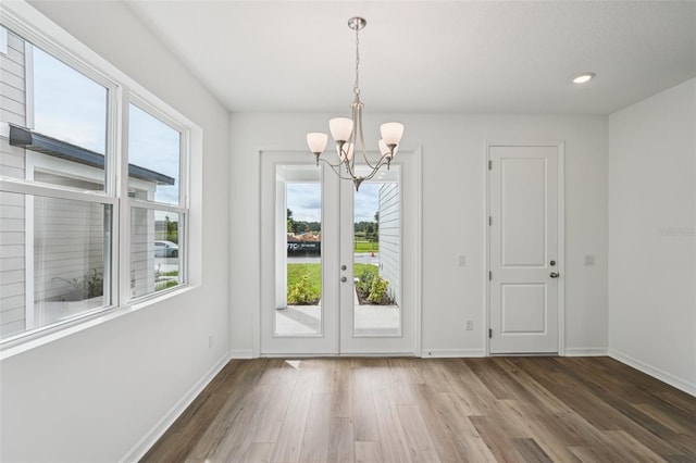 2467 Zuni Rd, Saint Cloud, FL 34771 - unfurnished dining area featuring a chandelier, wood finished floors, baseboards, and recessed lighting