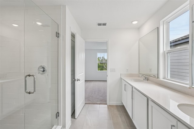 2467 Zuni Rd, Saint Cloud, FL 34771 - full bath featuring double vanity, a shower stall, baseboards, tile patterned floors, and recessed lighting