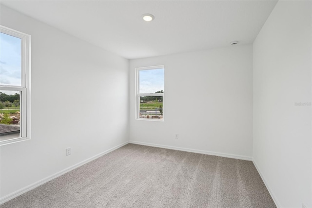 2467 Zuni Rd, Saint Cloud, FL 34771 - spare room with carpet floors, baseboards, and a smoke detector
