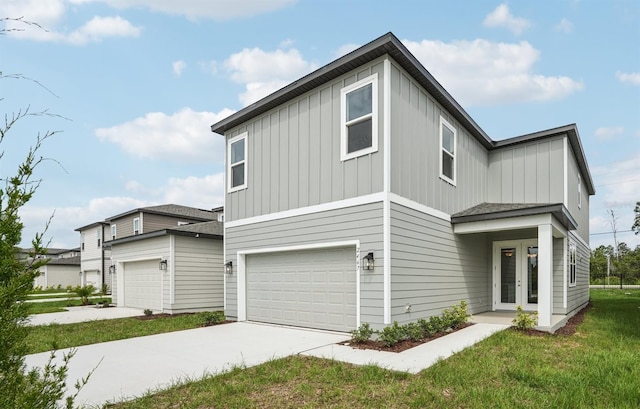 2467 Zuni Rd, Saint Cloud, FL 34771 - view of side of property featuring board and batten siding, french doors, concrete driveway, a yard, and a garage