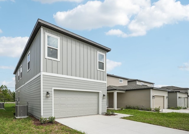 2467 Zuni Rd, Saint Cloud, FL 34771 - contemporary house featuring board and batten siding, central AC, driveway, and a garage