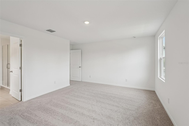 2467 Zuni Rd, Saint Cloud, FL 34771 - spare room featuring light colored carpet, baseboards, and recessed lighting