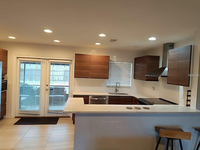 631 Trailwood Dr, Altamonte Springs, FL 32714 - kitchen with visible vents, a kitchen bar, wall chimney exhaust hood, a sink, and appliances with stainless steel finishes