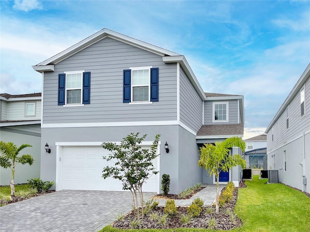 1820 Summer Dr, Davenport, FL 33897 - traditional-style home with an attached garage, decorative driveway, a front lawn, and stucco siding