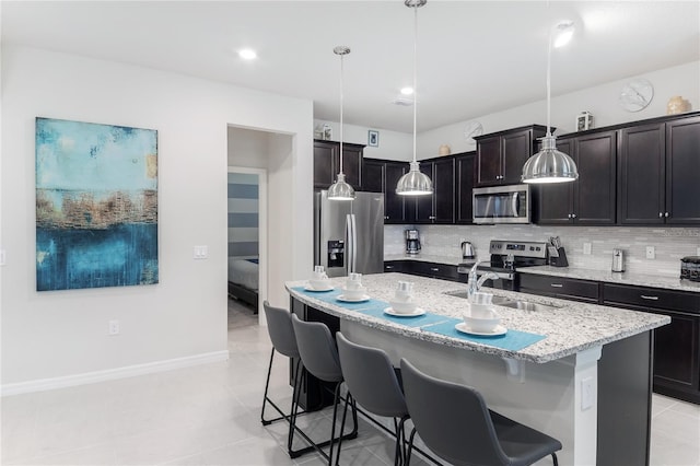 1820 Summer Dr, Davenport, FL 33897 - kitchen with stainless steel appliances, a kitchen breakfast bar, a sink, and tasteful backsplash
