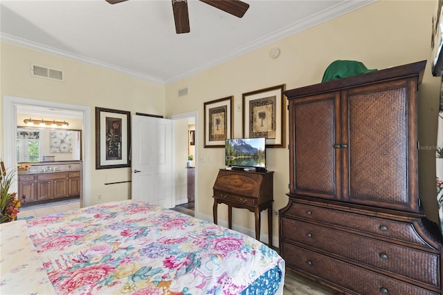 7630 Heritage Crossing Way Unit 302, Reunion, FL 34747 - bedroom with crown molding, ensuite bathroom, ceiling fan, and baseboards
