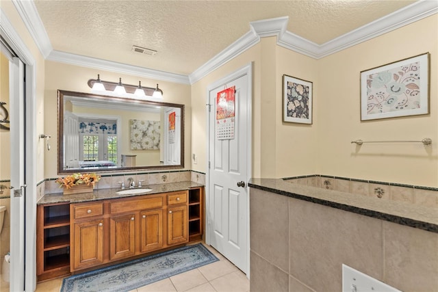 7630 Heritage Crossing Way Unit 302, Reunion, FL 34747 - bathroom featuring toilet, vanity, ornamental molding, tile patterned floors, and a textured ceiling