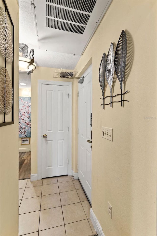 7630 Heritage Crossing Way Unit 302, Reunion, FL 34747 - hall with light tile patterned floors and baseboards