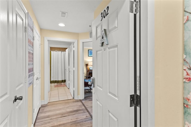 7630 Heritage Crossing Way Unit 302, Reunion, FL 34747 - hall with light wood-style floors, recessed lighting, and baseboards