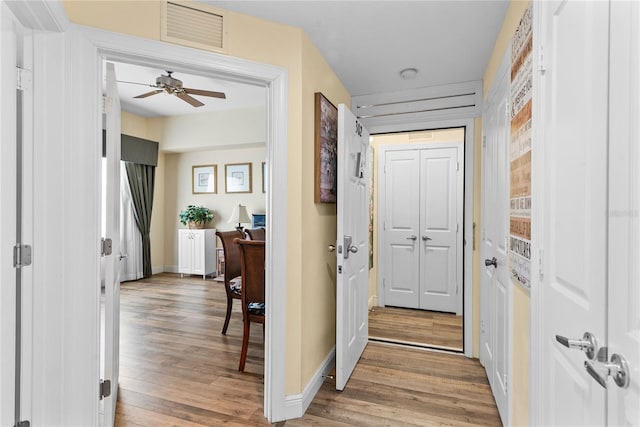 7630 Heritage Crossing Way Unit 302, Reunion, FL 34747 - hallway with light wood-type flooring and baseboards