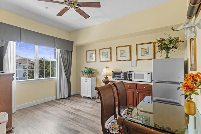 7630 Heritage Crossing Way Unit 302, Reunion, FL 34747 - office area featuring ceiling fan, light wood-type flooring, and baseboards
