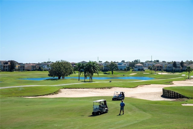 7630 Heritage Crossing Way Unit 302, Reunion, FL 34747 - view of property's community with golf course view, a lawn, a residential view, and a water view