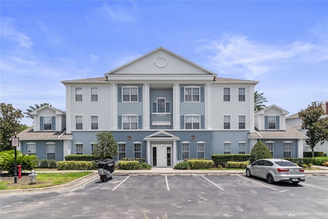 7630 Heritage Crossing Way Unit 302, Reunion, FL 34747 - view of building exterior with uncovered parking