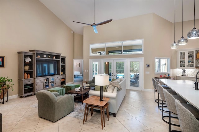 living room with light tile patterned floors, french doors, ceiling fan, and high vaulted ceiling