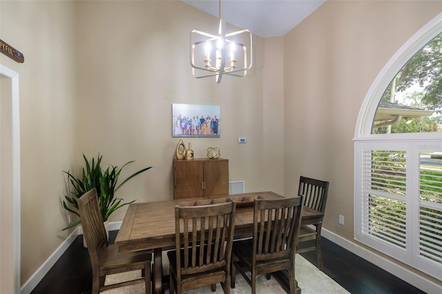 dining room with a chandelier, visible vents, baseboards, and dark wood-style floors