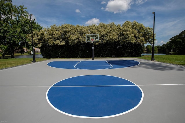view of sport court featuring a water view and community basketball court