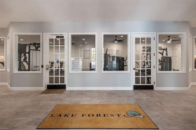 interior space featuring ceiling fan and baseboards