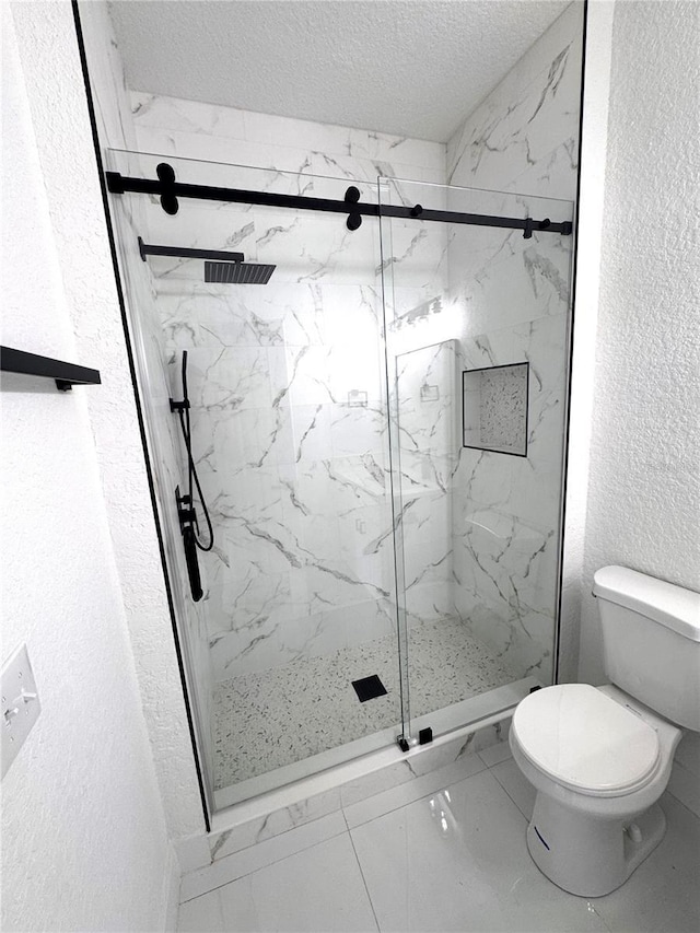 7147 Yacht Basin Ave Unit 119, Orlando, FL 32835 - bathroom featuring a textured ceiling, toilet, marble finish floor, a marble finish shower, and a textured wall