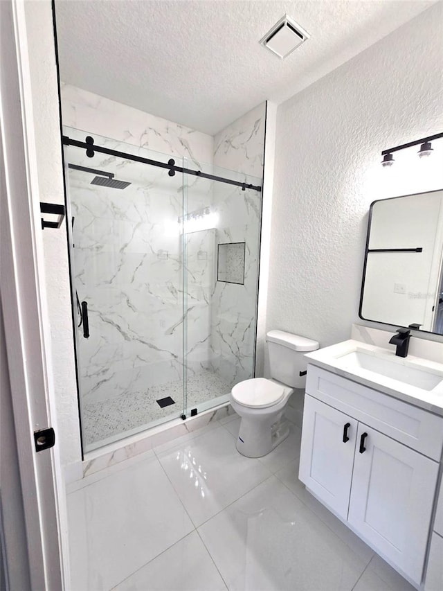 7147 Yacht Basin Ave Unit 119, Orlando, FL 32835 - bathroom with toilet, vanity, a textured ceiling, visible vents, and a textured wall