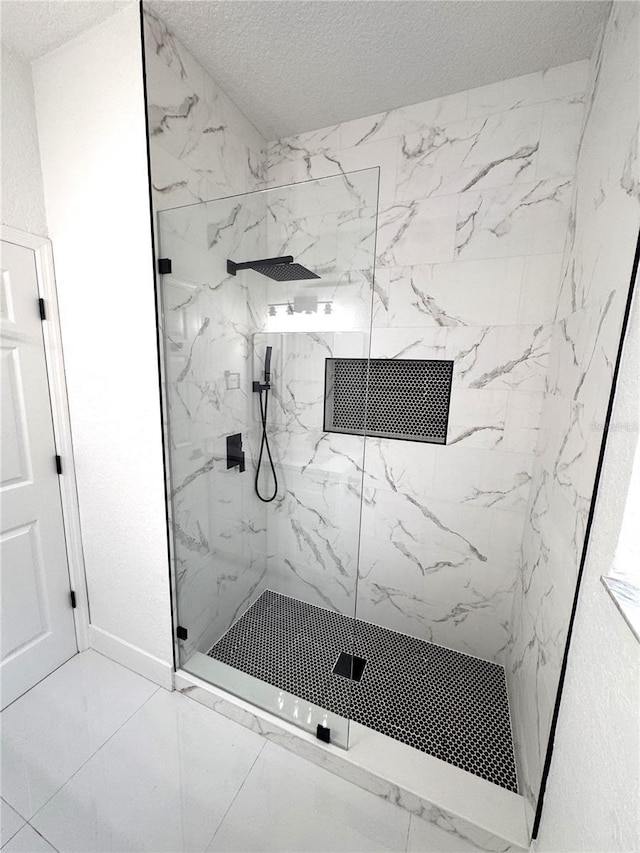 7147 Yacht Basin Ave Unit 119, Orlando, FL 32835 - full bathroom with a textured ceiling, a marble finish shower, marble finish floor, and baseboards