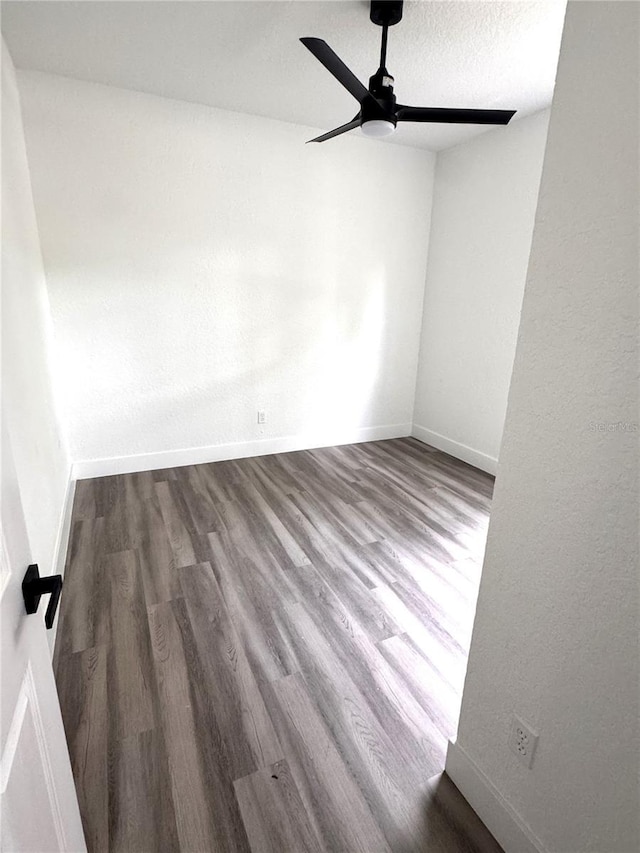 7147 Yacht Basin Ave Unit 119, Orlando, FL 32835 - empty room with baseboards, a ceiling fan, and wood finished floors