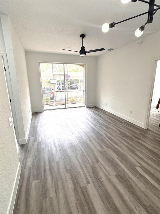 7147 Yacht Basin Ave Unit 119, Orlando, FL 32835 - empty room with baseboards, visible vents, ceiling fan, and dark wood-type flooring