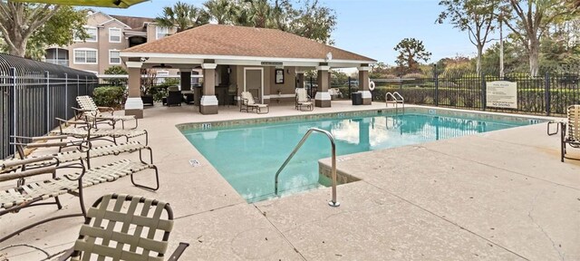 7147 Yacht Basin Ave Unit 119, Orlando, FL 32835 - pool featuring an outdoor structure, a patio, and fence