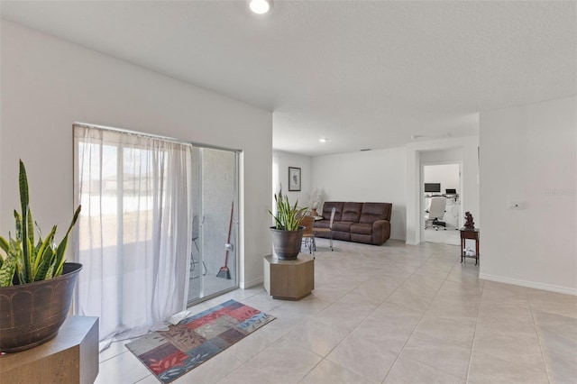 living room featuring light tile patterned floors, baseboards, and recessed lighting