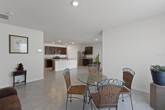dining space featuring recessed lighting, baseboards, visible vents, and light tile patterned floors