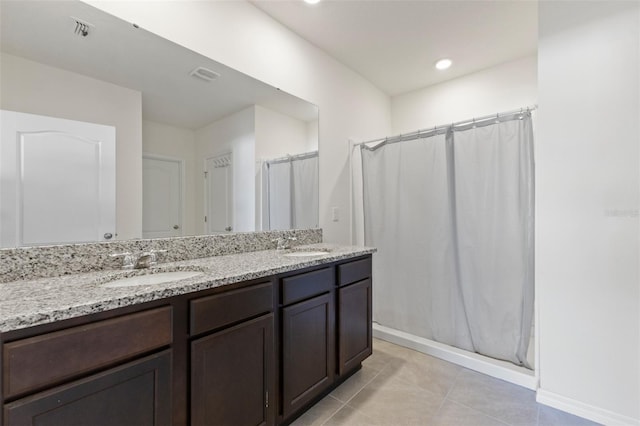 bathroom featuring a sink, tile patterned flooring, double vanity, and a shower with shower curtain