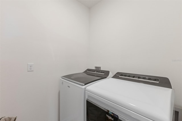 laundry room with separate washer and dryer and laundry area