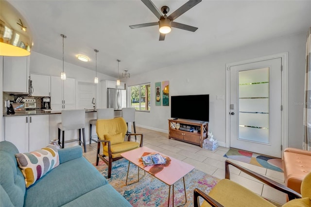 440 E Crystal Lake St, Orlando, FL 32806 - living area with a ceiling fan, baseboards, vaulted ceiling, and light tile patterned floors