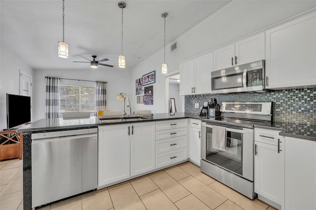 440 E Crystal Lake St, Orlando, FL 32806 - kitchen with visible vents, appliances with stainless steel finishes, a sink, light tile patterned floors, and a peninsula