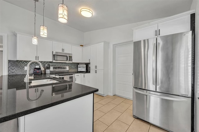 440 E Crystal Lake St, Orlando, FL 32806 - kitchen featuring a sink, backsplash, white cabinets, and stainless steel appliances