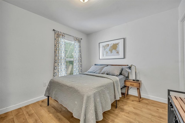 440 E Crystal Lake St, Orlando, FL 32806 - bedroom with baseboards and light wood-style flooring
