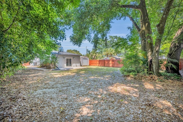 440 E Crystal Lake St, Orlando, FL 32806 - view of yard with a fenced backyard, an outbuilding, and a shed
