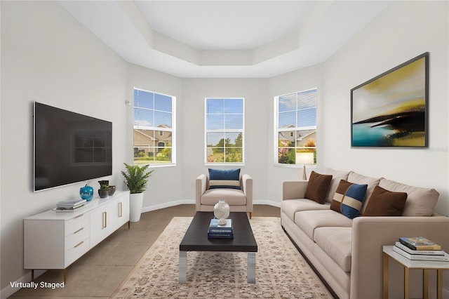 16780 Meadows St, Clermont, FL 34714 - tiled living room featuring a tray ceiling and baseboards