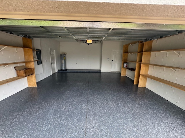 16780 Meadows St, Clermont, FL 34714 - garage featuring concrete block wall, a garage door opener, electric panel, and electric water heater