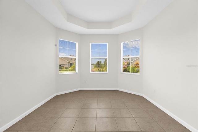 16780 Meadows St, Clermont, FL 34714 - spare room featuring healthy amount of natural light, light tile patterned floors, baseboards, and a tray ceiling